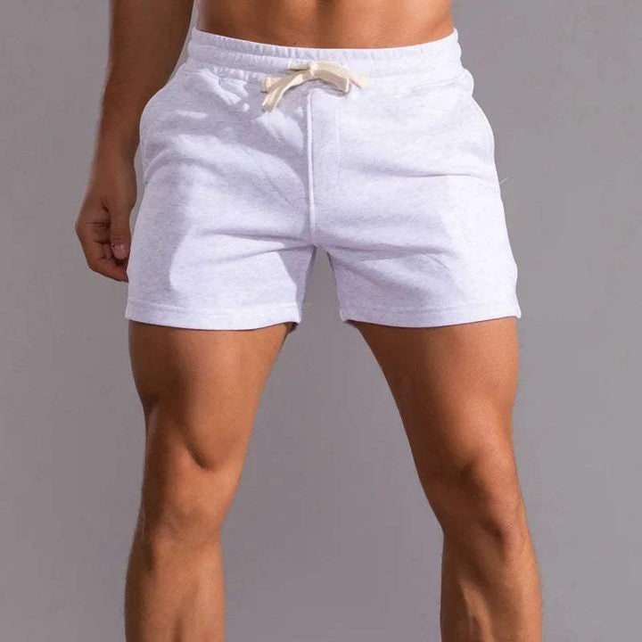 Shorts décontractés pour hommes avec taille élastique, en coton respirant et ajustement réglable avec poches latérales.
