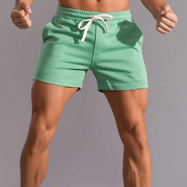Shorts décontractés pour hommes avec taille élastique, en coton respirant et ajustement réglable avec poches latérales.