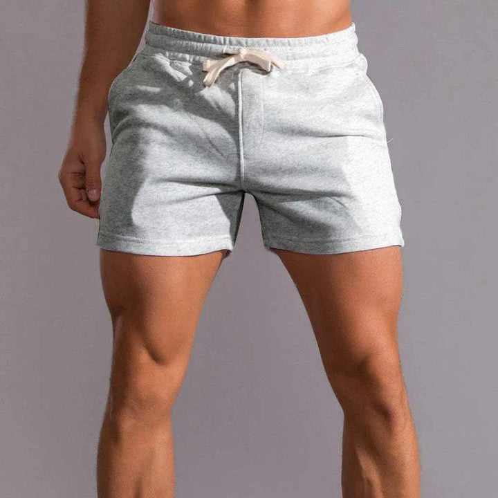 Shorts décontractés pour hommes avec taille élastique, en coton respirant et ajustement réglable avec poches latérales.
