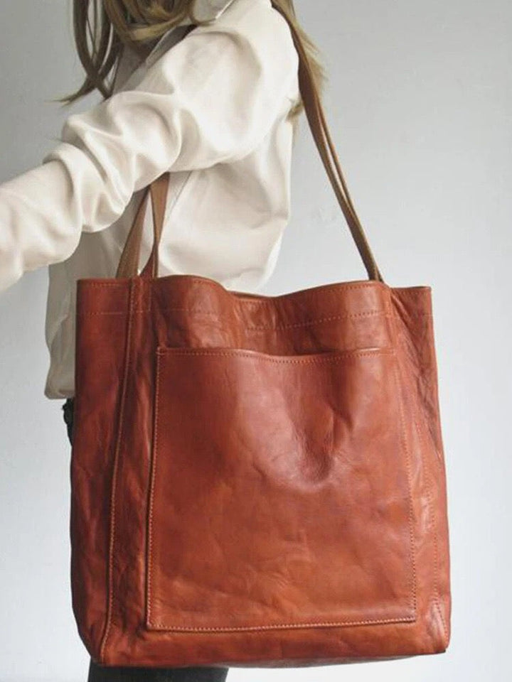 Nova - Élégante sac en cuir avec fermeture par bouton-pression et espace de rangement supplémentaire.