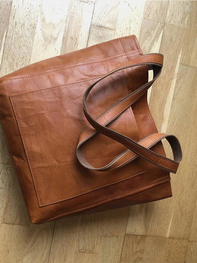Nova - Élégante sac en cuir avec fermeture par bouton-pression et espace de rangement supplémentaire.