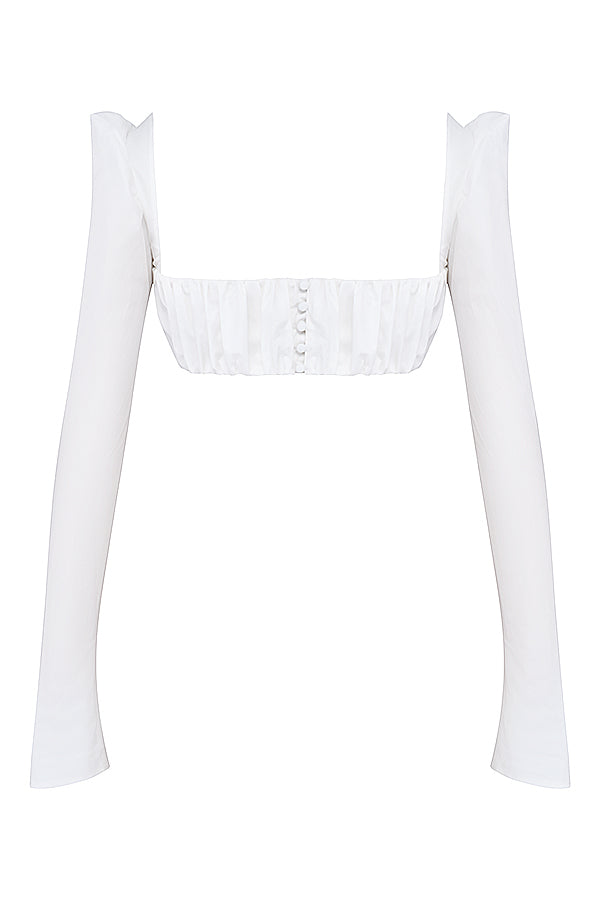 Top crop blanc élégant avec des manches bouffantes et une mini-jupe chic pour un look tendance.