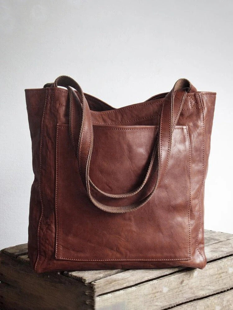 Nova - Élégante sac en cuir avec fermeture par bouton-pression et espace de rangement supplémentaire.