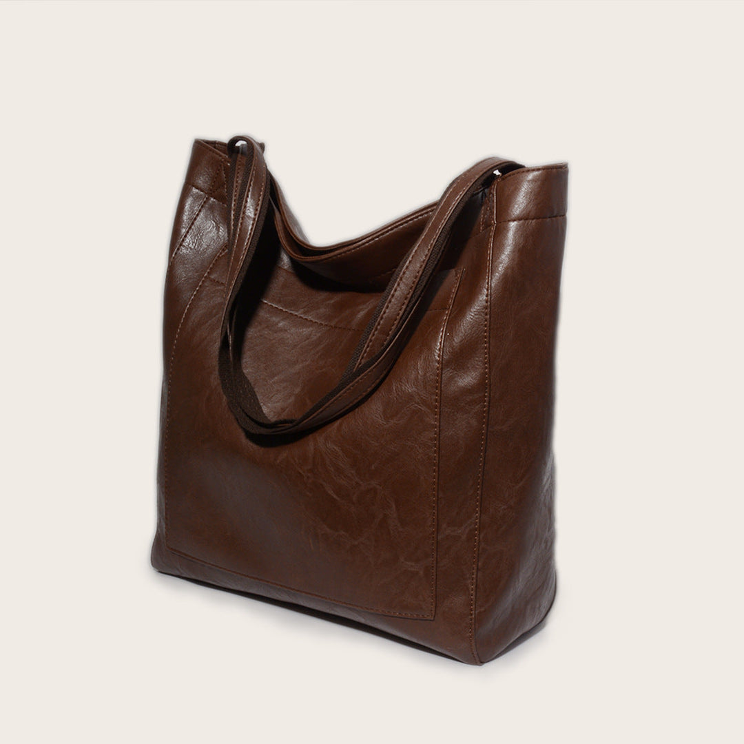 Nova - Élégante sac en cuir avec fermeture par bouton-pression et espace de rangement supplémentaire.